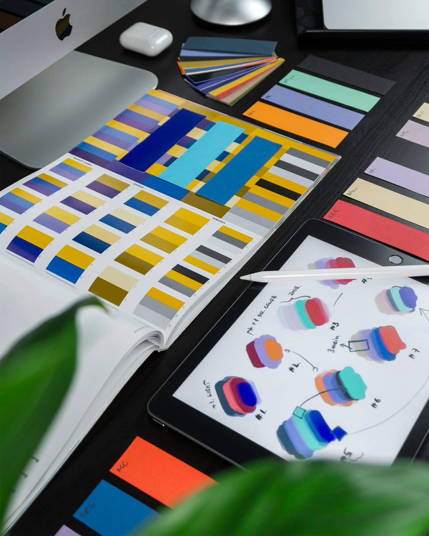 Design tools on a desk — screens get argued with before they become tickets